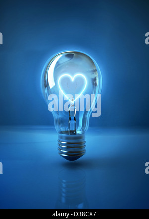 Illustrative image of heart shaped filament in light bulb representing love over blue background Stock Photo