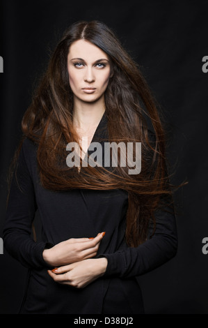 The beautiful long-legs woman I have ever seen posing at the studio.She has long hair and slim legs. Stock Photo