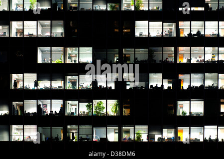 Windows in an office building at night Stock Photo