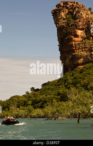 A Zodiac from the Aussie expedition cruiser Orion skims past Indian Head rock in Frederick Harbour, Western Australia Stock Photo