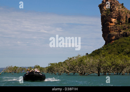 A Zodiac from the Aussie expedition cruiser Orion skims past Indian Head rock in Frederick Harbour, Western Australia Stock Photo