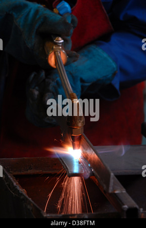 Man welding, fabrication, construction, building, sparks, danger, recession, engineering, making, work, employment, gdp, Stock Photo