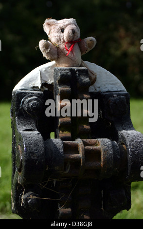 A small teddy bear has been found and placed on the lock working cog gear of a lock on the Shropshire Union Canal in Cheshire Stock Photo