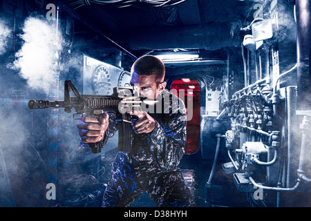 Soldier shooting assault rifle indoors Stock Photo