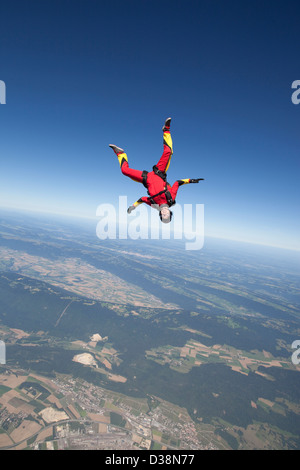 Woman skydiving over rural landscape