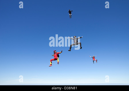People skydiving over clouds Stock Photo