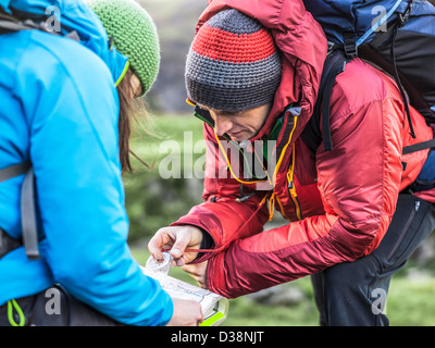Hikers using map and compass Stock Photo