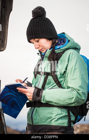 Hiker taking notes in rural landscape Stock Photo