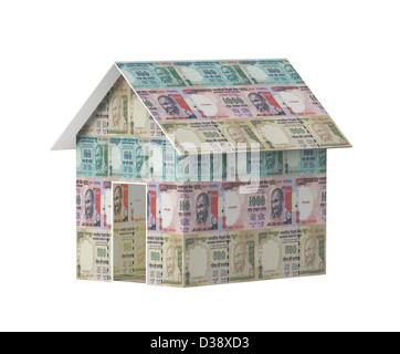 Close-up of a model home covered with rupees Stock Photo