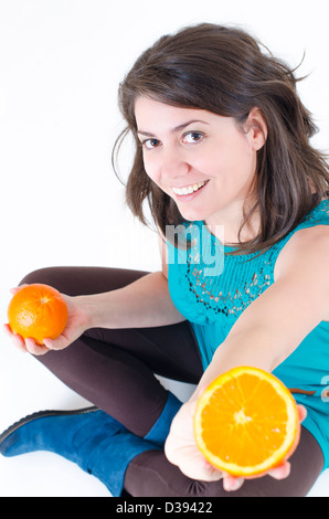 A young beautiful woman holding oranges Stock Photo