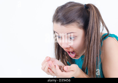 A insatiable girl girl holding a piece of chocolate Stock Photo