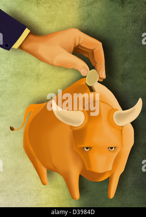 Human hand putting coin in bull piggy bank depicting the concept of investment in stock market Stock Photo