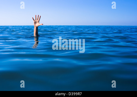 Help needed. Drowning man's hand in sea or ocean. Stock Photo