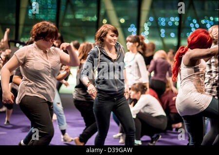 London, UK. 12th February 2013. Members of One Billlion Rising V Day flashmob rehearse what will be the first flashmob inside London's City Hall. Credit:  Carole Edrich / Alamy Live News Stock Photo