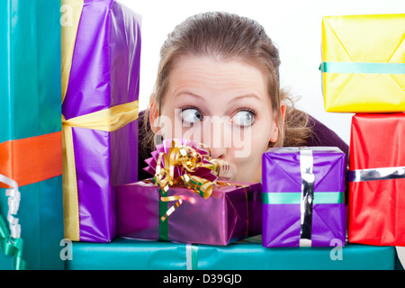 young attractive woman makes big eyes because of many gifts Stock Photo