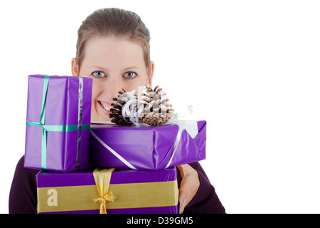 attractive young woman with many gifts smiles to the viewer Stock Photo