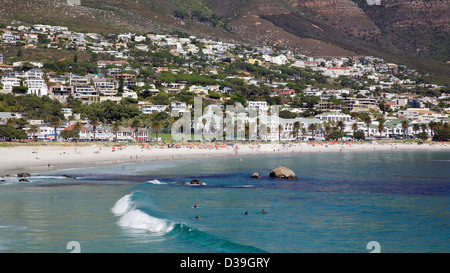 Surfers waiting for the perfect wave at Camps Bay Beach in Cape Town, South Africa, on April 11, 2012. Stock Photo