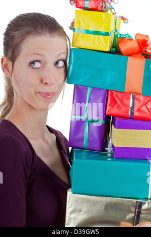 pretty young woman carrying a stack of gifts Stock Photo