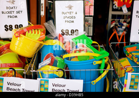 Colorful buckets and spades on sale outside a store in Byron Bay, Australia with dollar price tags to the rear. Stock Photo