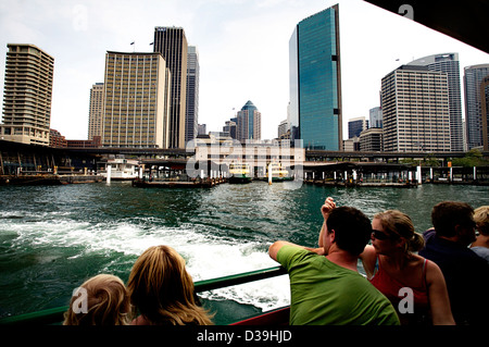 People looking at the Sydney skyline as the Sydney Ferry pulls out of Circular Quay, Sydney Australia Stock Photo