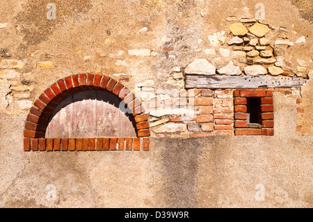 Old brick arch in wall - France. Stock Photo