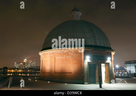 Greenwich Foot Tunnel with Canary Wharf and the Docklands in the background pictured at night. Stock Photo