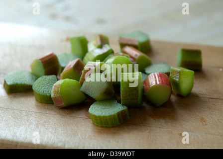 close up image of sliced rhubarb on a wooden shopping board ready for cooking. Stock Photo