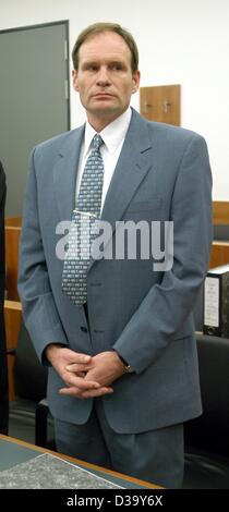 (dpa) - 42-year-old German computer specialist Armin Meiwes stands with his hands folded during his trial at the district court in Kassel, Germany, 22 December 2003. The German murder trial of the self-declared cannibal continues on its fifth day. Meiwes has admitted killing and eating his victim bu Stock Photo