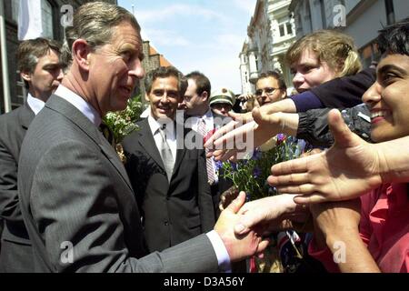 (dpa) - The Prince of Wales shakes hands with an enthusiastic crowd at the town hall square in Luebeck, Germany, 11 June 2002. The occasion for his two-day official visit to Germany is the granting of the European Natural Heritage Fund 2002 environmental prize. Prince Charles is honoured for his pro Stock Photo