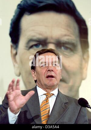 (dpa) - German Chancellor Gerhard Schroeder speaks in front of an election poster with his portrait at a press conference in Berlin, 3 June 2002. The general elections in Germany will be held on 22 September 2002. Stock Photo