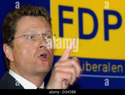 (dpa) - Guido Westerwelle, Chairman of the German liberal party FDP, speaks in front of his party's logo at a party meeting in Passau, Germany, 13 February 2002. In the general elections on 22 September 2002 Westerwelle is running for chancellor, which makes him the first chancellor candidate in the