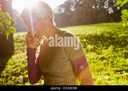 Woman talking on cell phone in park Stock Photo