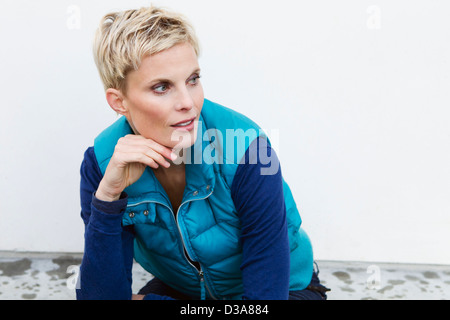 Woman resting chin in hand outdoors Stock Photo