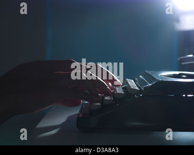 Close up of woman using typewriter Stock Photo