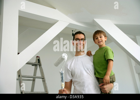 Father and son painting new house Stock Photo