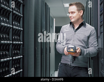 Man working in server room Stock Photo