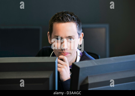 Man using computers at desk Stock Photo