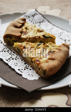 Two slices of vegetarian tart with zucchini, onion and tofu Stock Photo