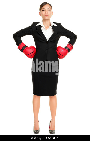 Full length of confident young mixed race businesswoman wearing boxing gloves ready for the competition on white background Stock Photo