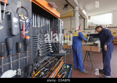 Mechanics working in garage Stock Photo