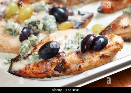 Mediterranean food of Provence, chicken fillet roasted with blue cheese, grapes and olives Stock Photo