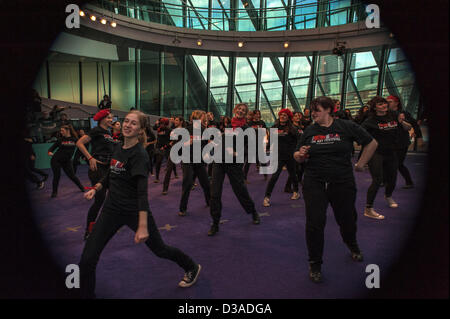 London, UK. 14th February 2013. Members of One Billlion Rising V Day flashmob celebrate the first flashmob inside London's City Hall. Credit:  Carole Edrich / Alamy Live News Stock Photo