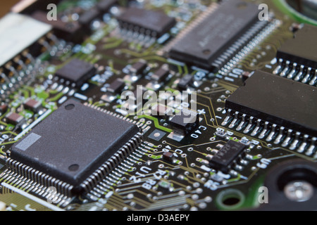 Microchips surrounded by other elements on a circuit board Stock Photo