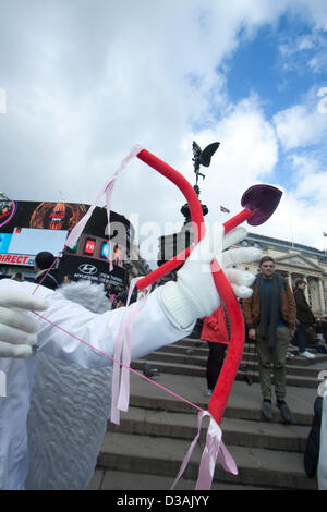 14th February 2013. Piccadilly, London, UK. A man dressed as cupid Eros the God of Passionate love in Greek mythology holds a bow and arrow in front of the statue of Eros in Piccadilly Circus on Valentine's day. Credit Amer Ghazzal/Alamy live news. Stock Photo