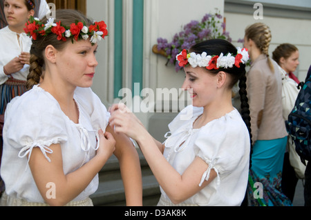 Latvian girls wearing flower head bands taking part in a choir as part of the annual Latvian cultural festival in Riga,Latvia Stock Photo