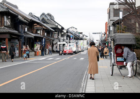 February 14, 2013, Kawagoe, Japan - Tourist visit the stores along the main street of Little Edo, Kawagoe. An old town from Edo Period (1603-1867) is located in Kawagoe, 30 minutes by train from central Tokyo. In the past Kawagoe was an important city for trade and strategic purpose, the shogun installed some of their most important loyal men as lords of Kawagoe Castle. Every year 'Kawagoe Festival' is held in the third weekend of October, people pull portable shrine during the parade, later 'dashi' floats on the streets nearby. The festival started 360 years ago supported by Nobutsuna Matsuda Stock Photo