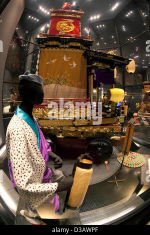 February 14, 2013, Kawagoe, Japan - A doll wearing traditional Japanese clothes and dashi (portable shrine) at the Kawagoe Festival Museum. An old town from Edo Period (1603-1867) is located in Kawagoe, 30 minutes by train from central Tokyo. In the past Kawagoe was an important city for trade and strategic purpose, the shogun installed some of their most important loyal men as lords of Kawagoe Castle. Every year 'Kawagoe Festival' is held in the third weekend of October, people pull portable shrine during the parade, later 'dashi' floats on the streets nearby. The festival started 360 years a Stock Photo