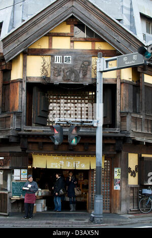 February 14, 2013, Kawagoe, Japan - Tourist visit the stores along the main street of Little Edo, Kawagoe. An old town from Edo Period (1603-1867) is located in Kawagoe, 30 minutes by train from central Tokyo. In the past Kawagoe was an important city for trade and strategic purpose, the shogun installed some of their most important loyal men as lords of Kawagoe Castle. Every year 'Kawagoe Festival' is held in the third weekend of October, people pull portable shrine during the parade, later 'dashi' floats on the streets nearby. The festival started 360 years ago supported by Nobutsuna Matsuda Stock Photo