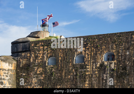 Interior view of El Morro Fortress showing flags and lighthouse, San Juan, Puerto Rico Stock Photo