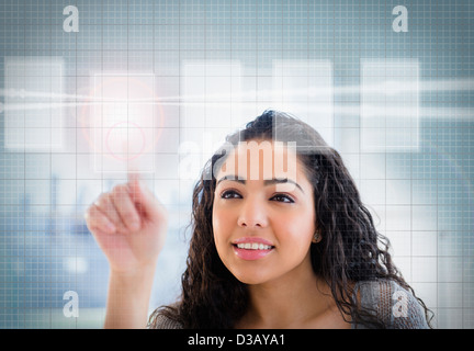 Hispanic woman using touch screen Stock Photo